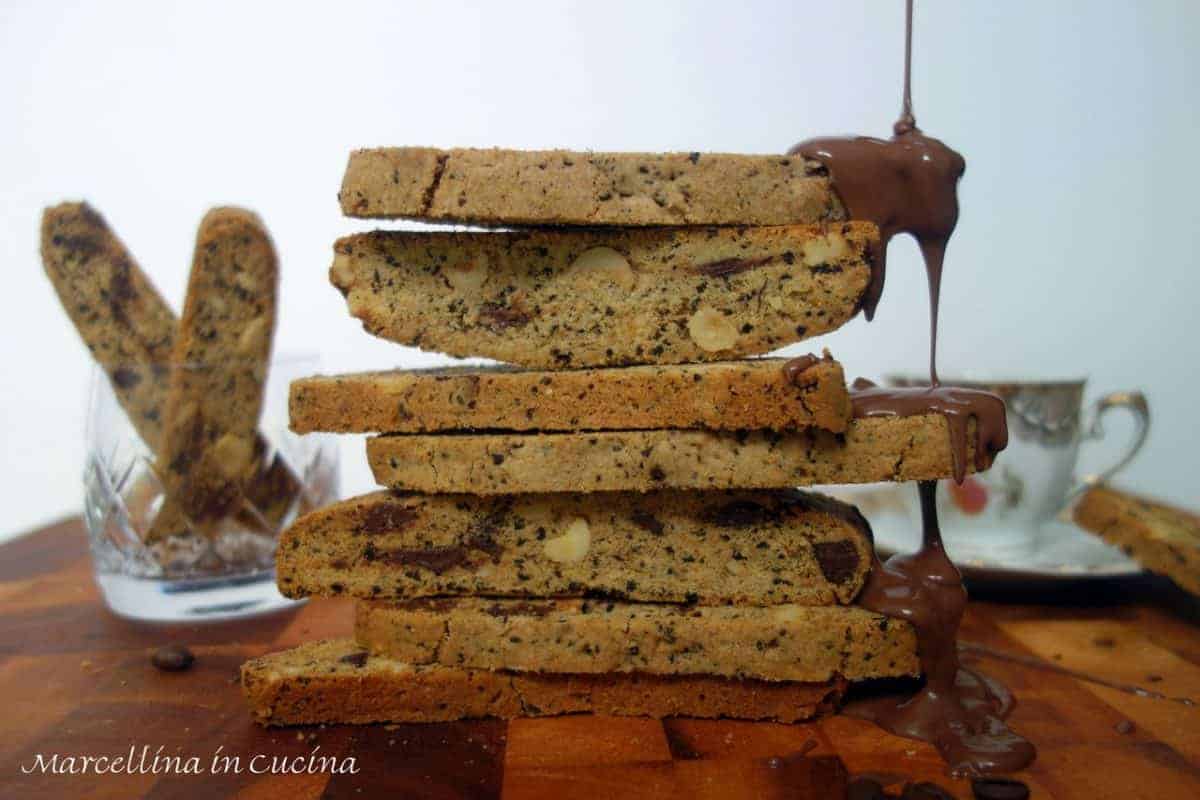 coffee biscotti stacked with chocolate dripping down one side.