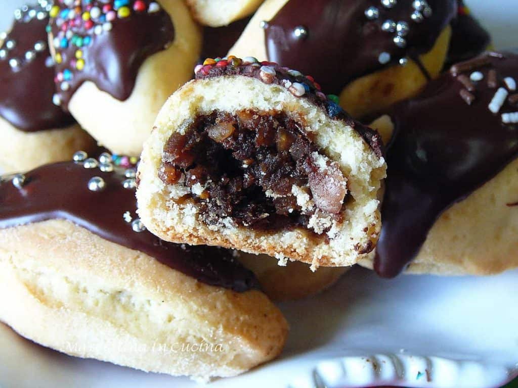 Plate of Petrali - Calabrian Fig Cookies with chocolate icing cut in half