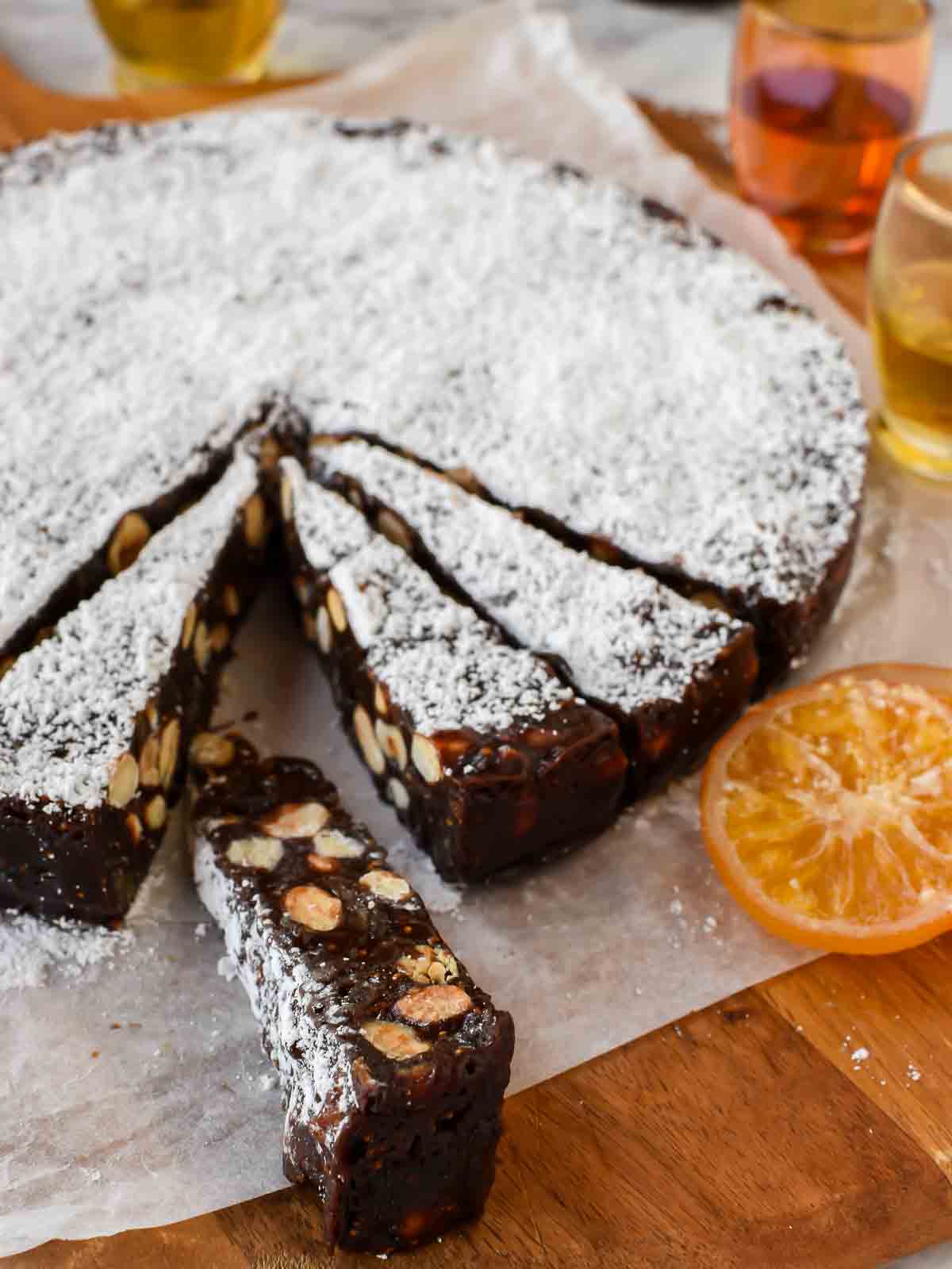 round cake of panforte with a few slices cut.