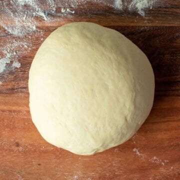 A ball of pale yellow dough viewed from above.