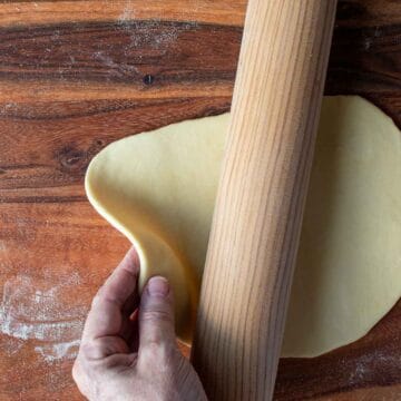 Pasta dough rolled thickly viewed from above.