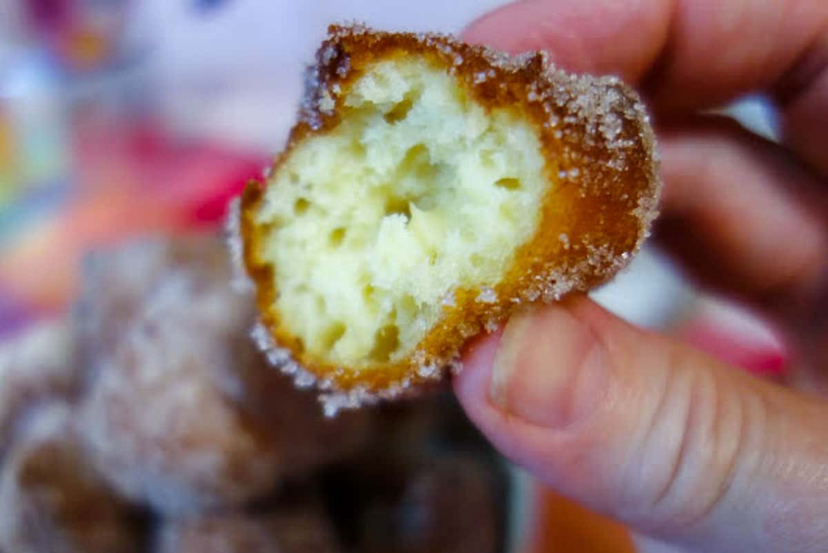 close up of cross section of fried dough ball.