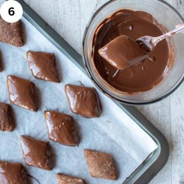 Diamond shaped brown cookies being dipped in melted chocolate.