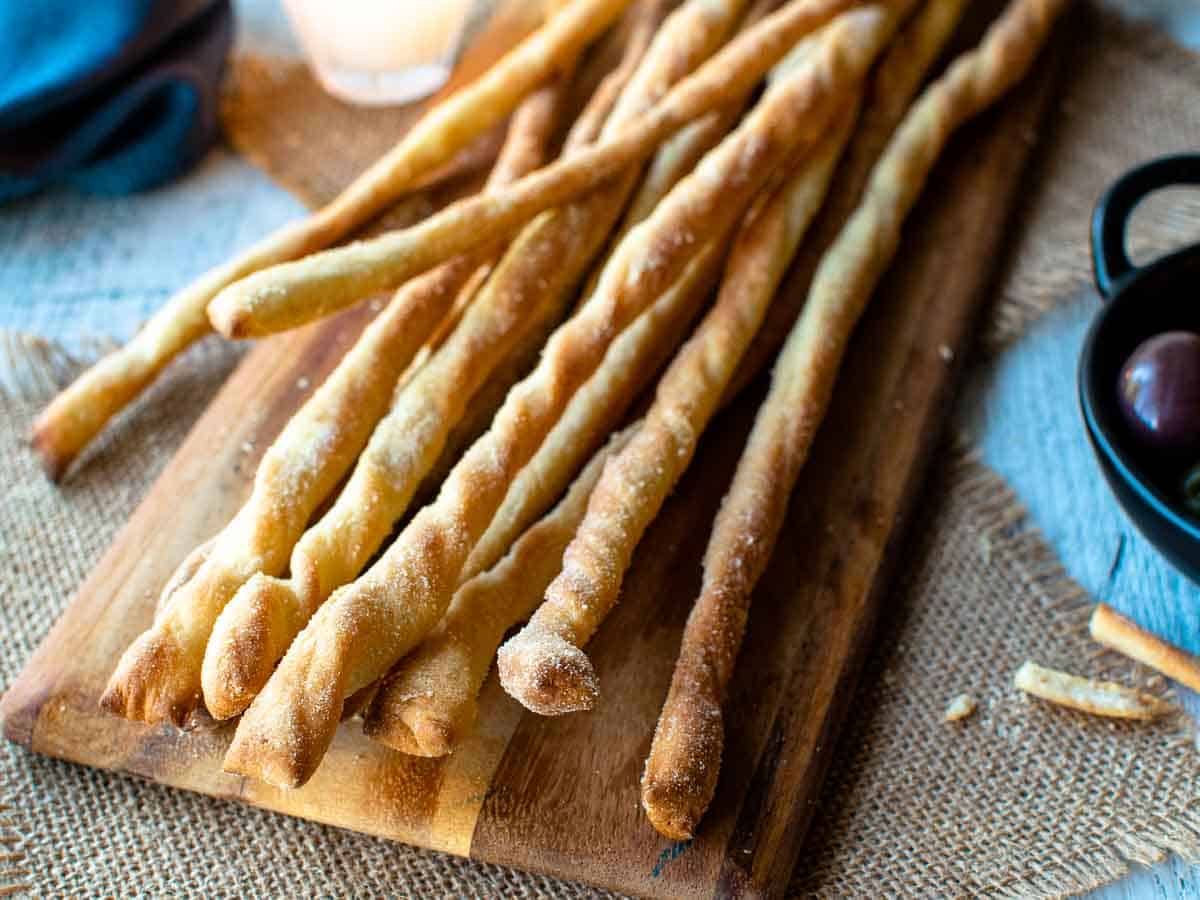 Breadsticks on a wooden board.