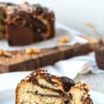 Wedge of nutella bread with swirls of chocolate inside on a white plate.