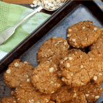 Overhead view of Anzac Biscuits in dark coloured baking tray