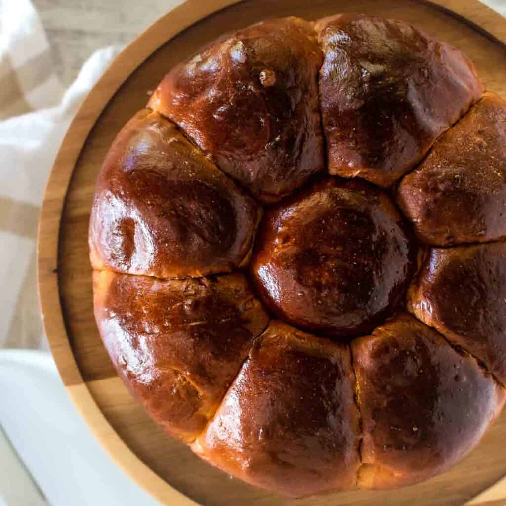 Portuguese Sweet Bread viewed from above on a wooden cake stand.