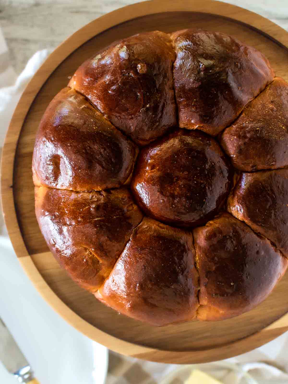 Portuguese Sweet Bread viewed from above on a wooden cake stand.