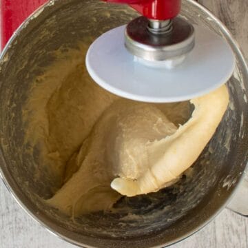 Dough being kneaded by an electric stand mixer.