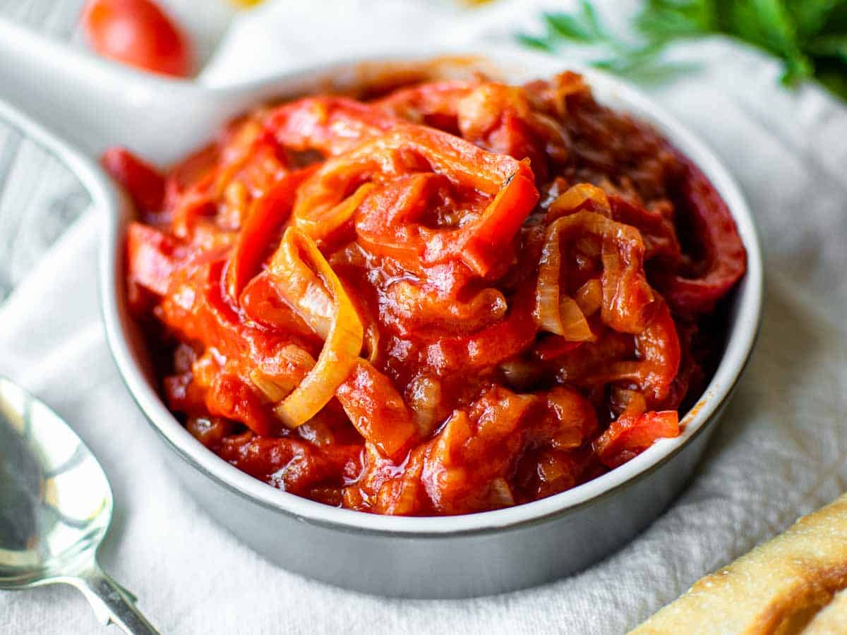 Close up of stewed bell peppers in tomato sauce.