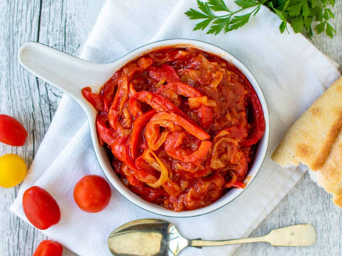 Overhead view of stewed bell peppers and tomato sauce.