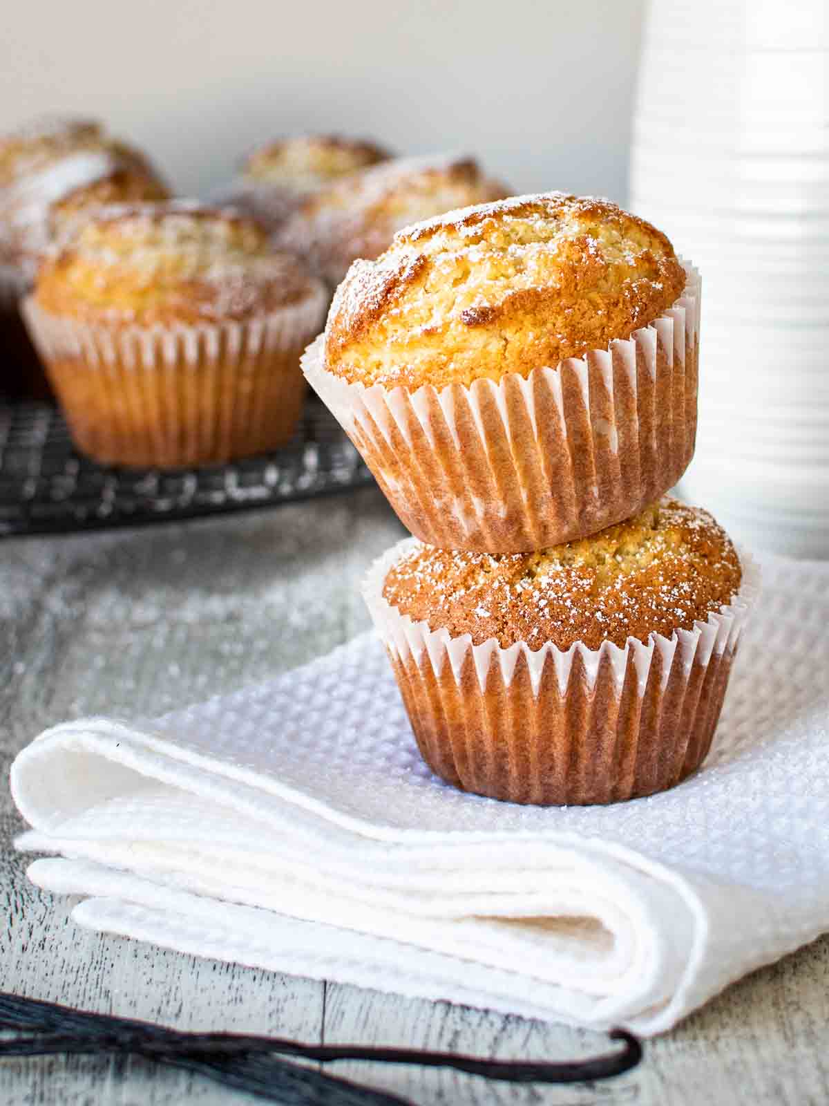 Two vanilla muffins stacked one on top of the other.