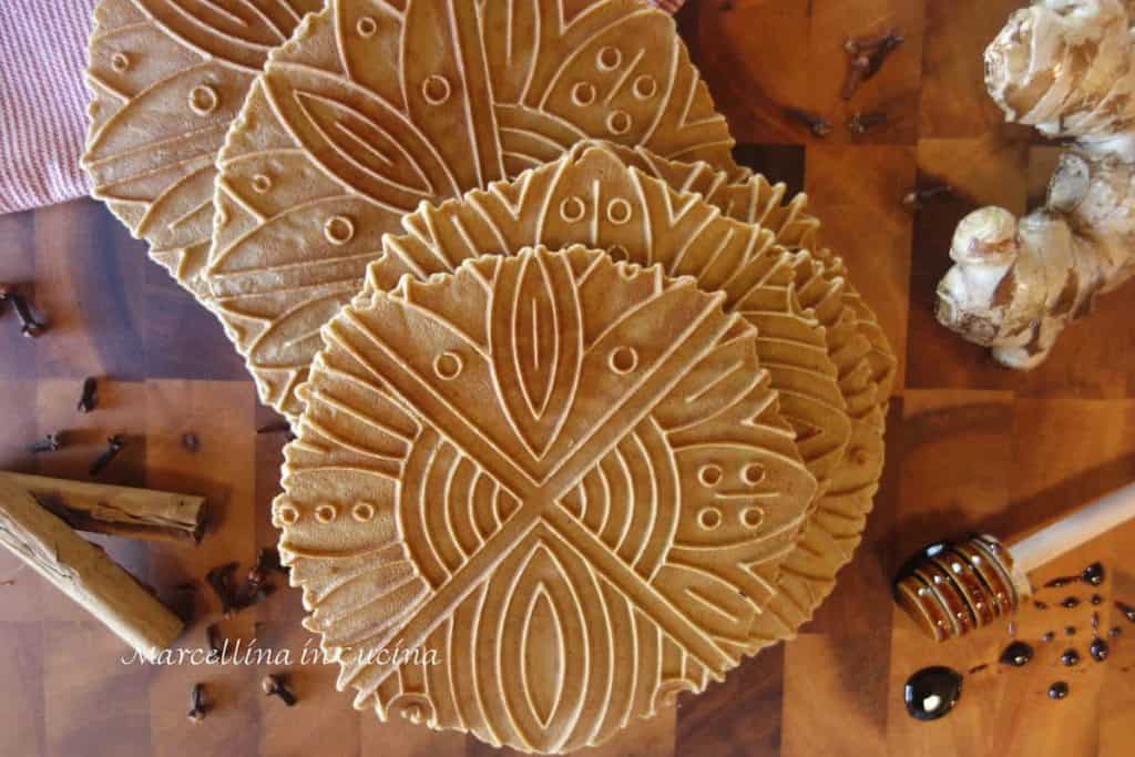 Gingerbread Pizzelle with cinnamon sticks, whole cloves, fresh ginger and molasses on a stick