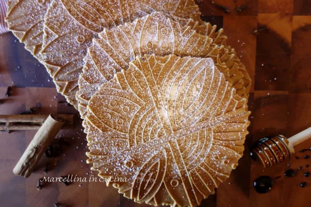 Gingerbread Pizzelle with cinnamon sticks, whole cloves and molasses on a stick