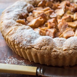close up of apple crostata with bone handle knife in front