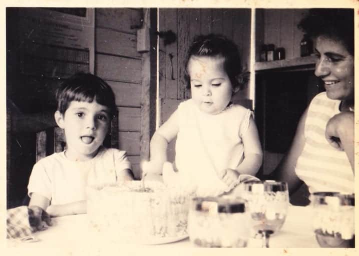 old black and white photo of mother with two small children.