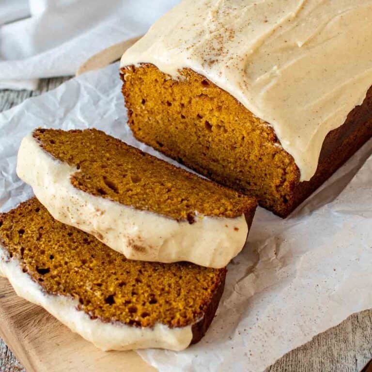 Pumpkin Bread with Cream Cheese Frosting with two slices cut.