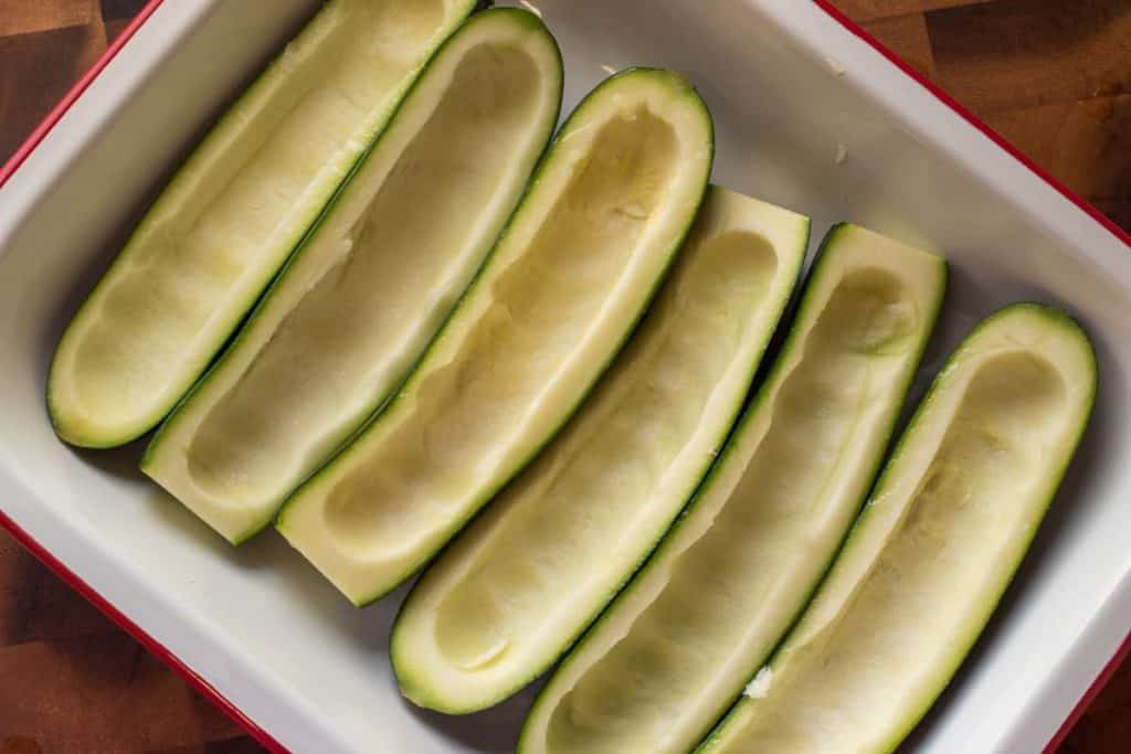 Six hollowed out green zucchini halves
