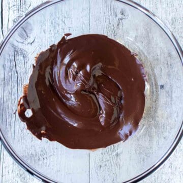 Melted dark chocolate in a bowl viewed from above.
