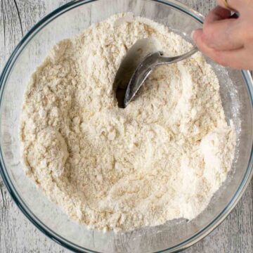 Spoon combining dry ingredients.