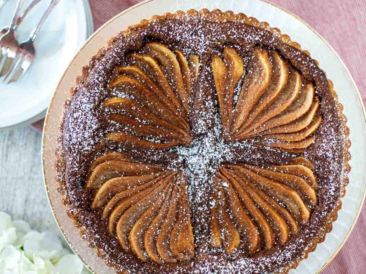 Overhead view of a tart with fanned slices of pears arranged on top.