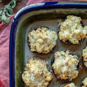 stuffed mushrooms in ceramic baking dish.