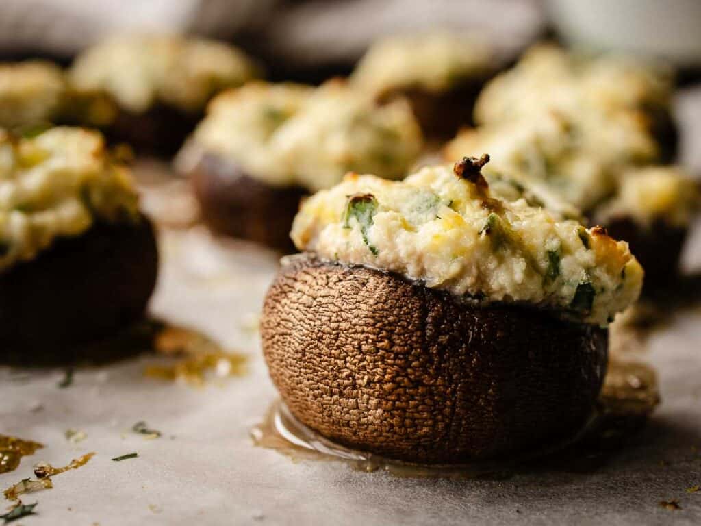 Closeup of a mushroom cap stuffed with creamy mixture.