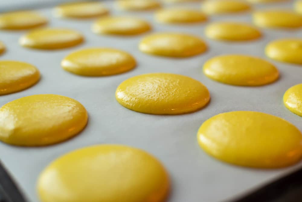 Yellow macarons ready for baking