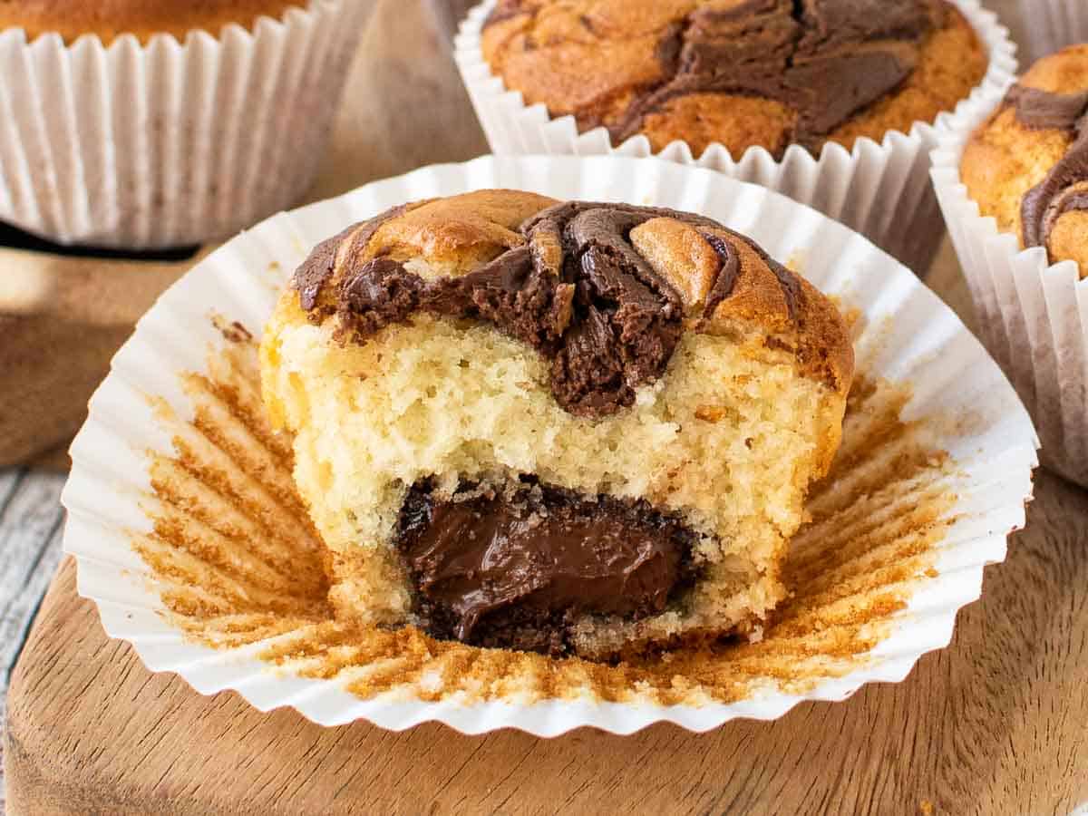 One muffin cut in half showing a center of Nutella.