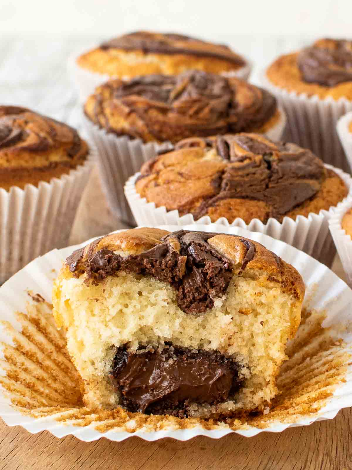 Nutella Muffins with one muffin cut in half revealing the center full of Nutella.