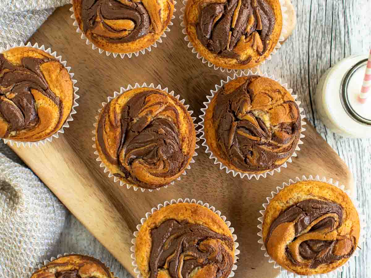 Overhead view of muffins with nutella swirled into the batter.