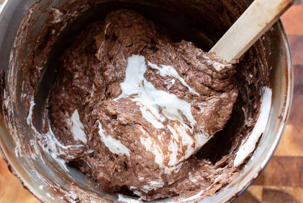 Chocolate almond cake batter and eggwhite being mixed