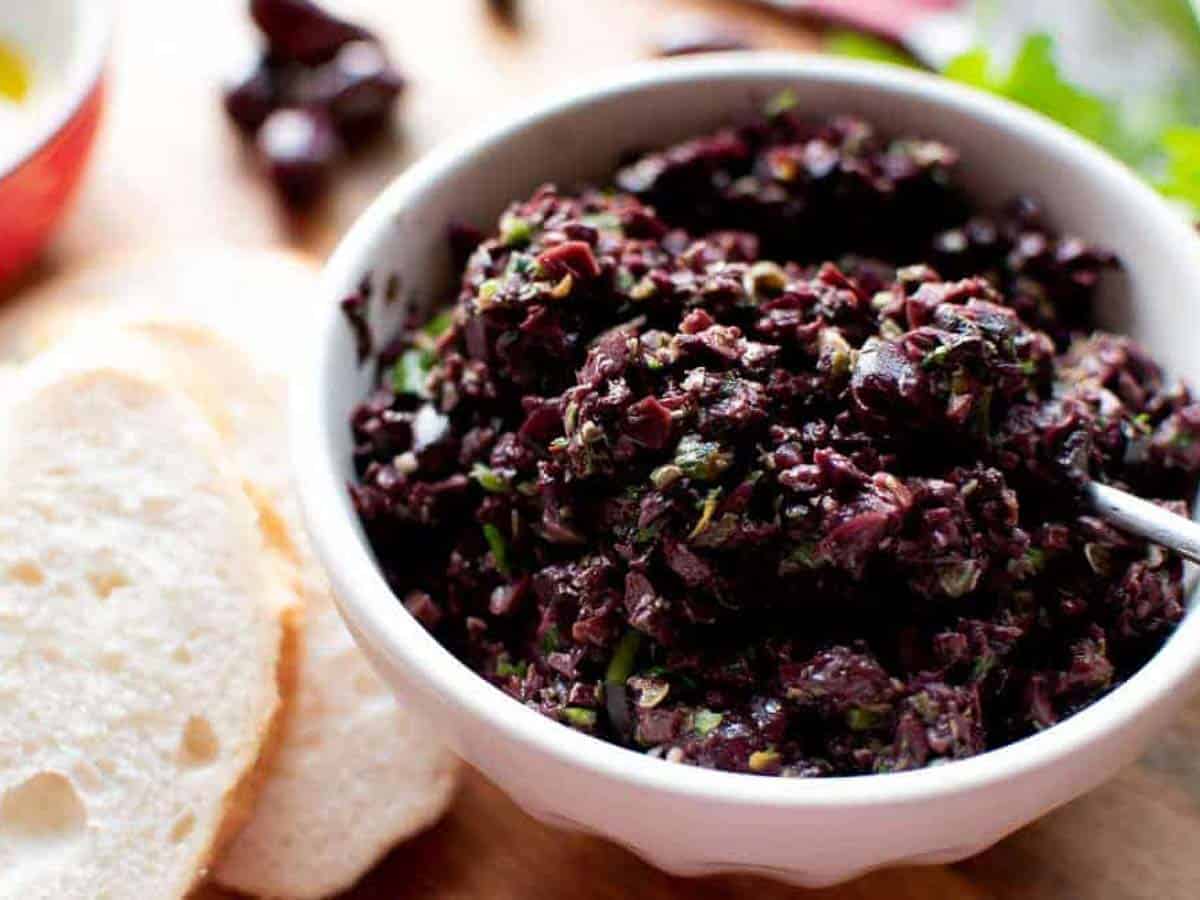 black olive paste in a white bowl.