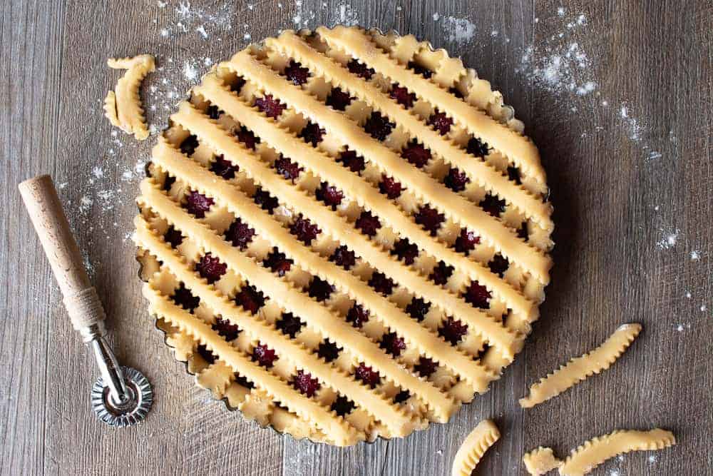 Top of unbaked strawberry crostata recipe with pastry lattice work.