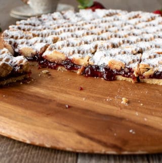 Strawberry crostata recipe cut with jam oozing