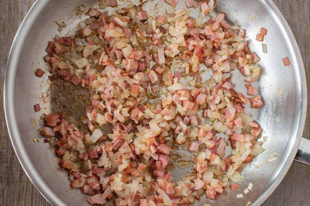 Onion, bacon and garlic in frying pan