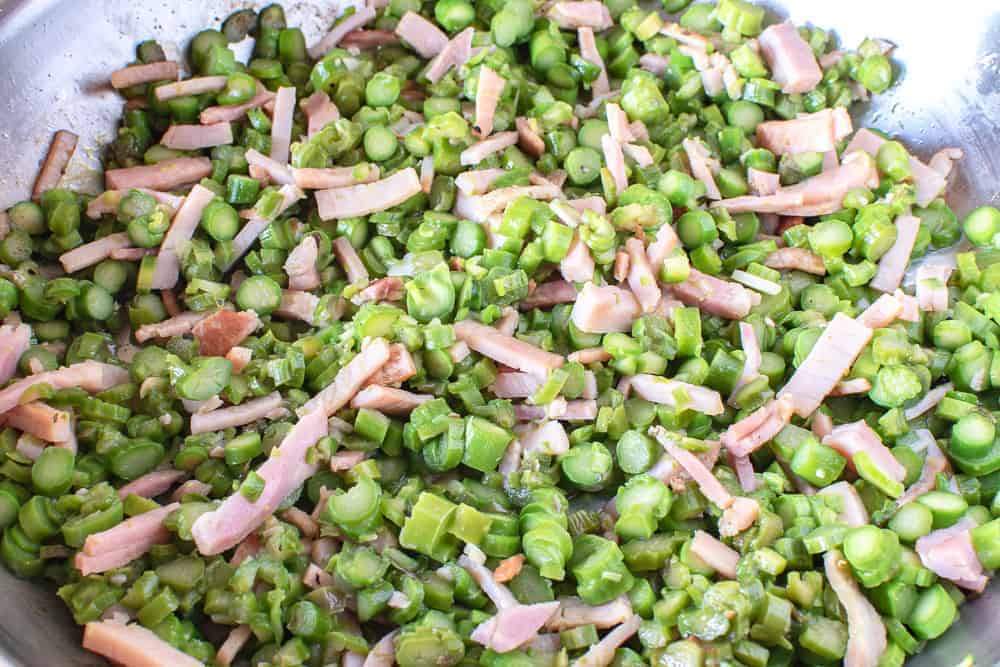 Asparagus and bacon in frying pan to make this Pasta recipe.