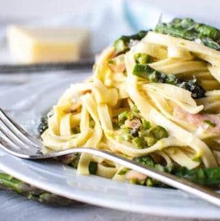 pasta with asparagus on white plate with fork