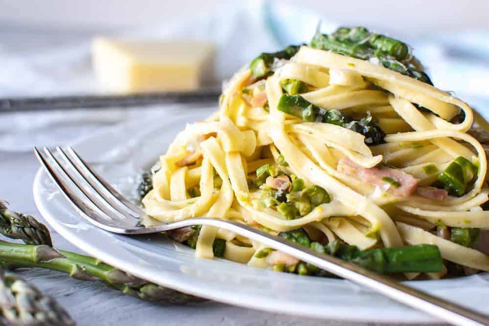 Bacon Asparagus Pasta on white plate with fork