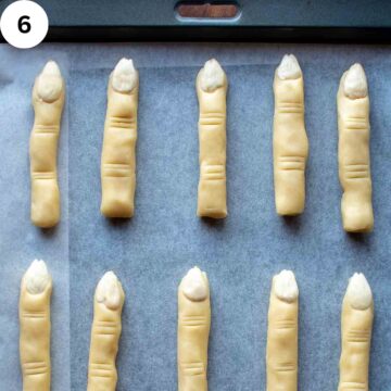 Cookies that look like fingers on parchment paper.