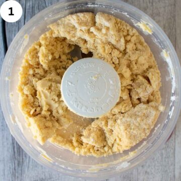 Cookie dough in a food processor viewed from above.