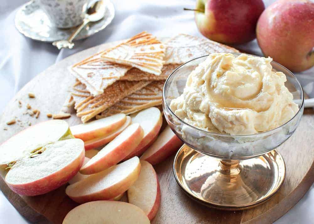 creamy ricotta on a board with apple slices and pizzelle.