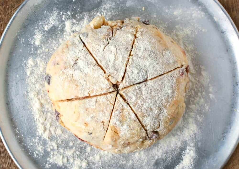 Ball of damper dough on aluminum round tray viewed from above.