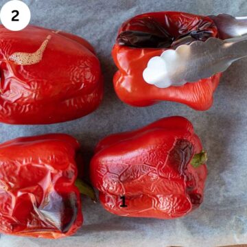 Roasted peppers with one being grasped with kitchen tongs.