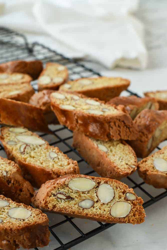 Italian Almond biscotti are easy to make at home. They are crunchy and perfect for dipping in vin santo or an espresso. #italianrecipe #almondbiscotti #italianalmondbiscotti #biscottirecipe almond biscotti on black wire rack.