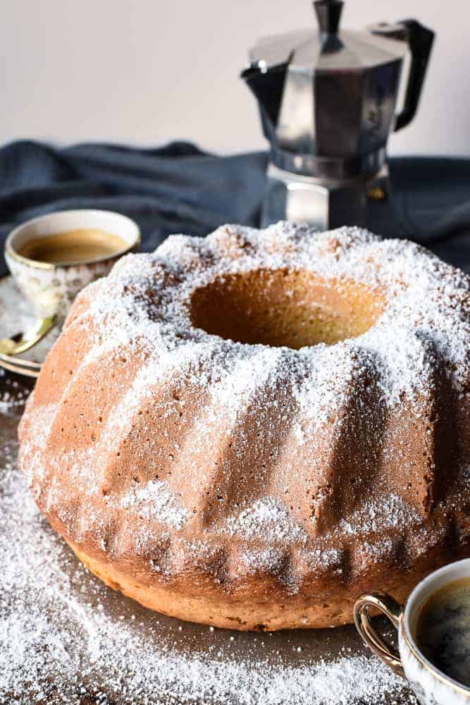 Bundt cake with two espresso cups of coffee and moka pot.