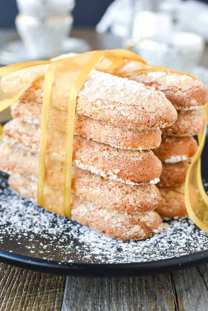 two stacks of sponge fingers (savoiardi) tied together with a gold ribbon