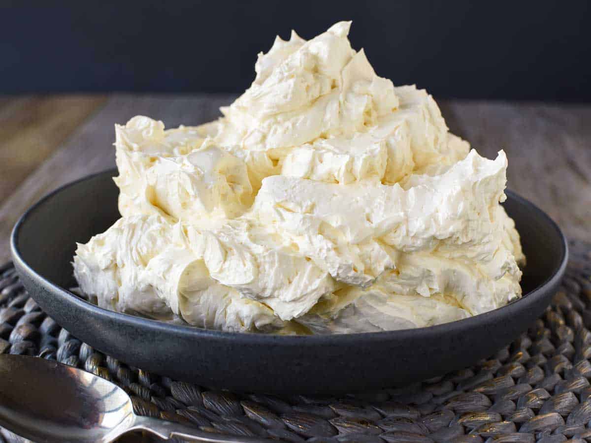 Thick creamy frosting piled high in a bowl.