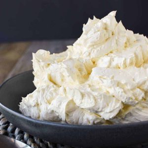 Italian meringue buttercream in black bowl viewed from the side