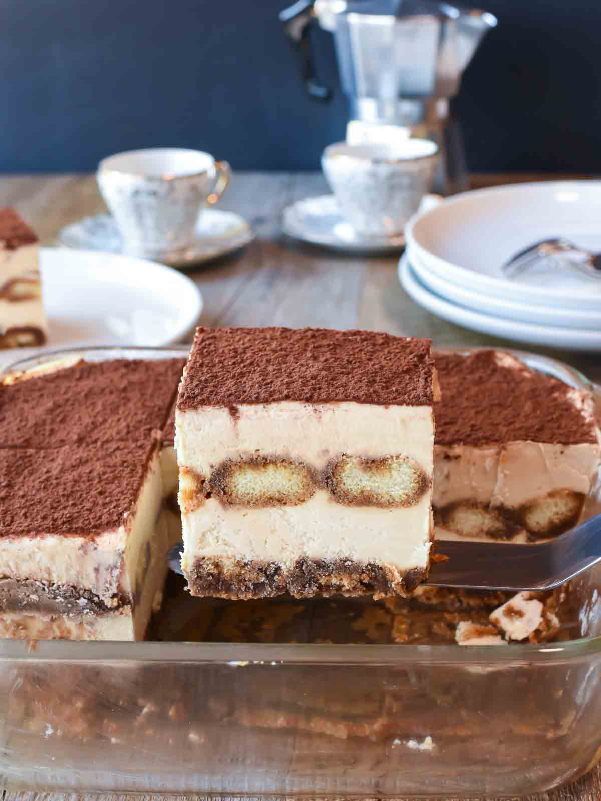 Cross section of creamy dessert topped with cocoa powder of lifted from serving dish.